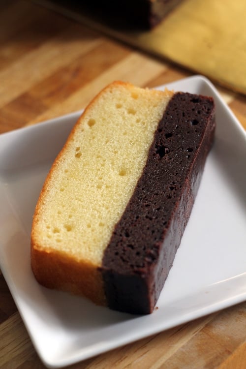 A slice of rich brownie butter cake, served in a plate.