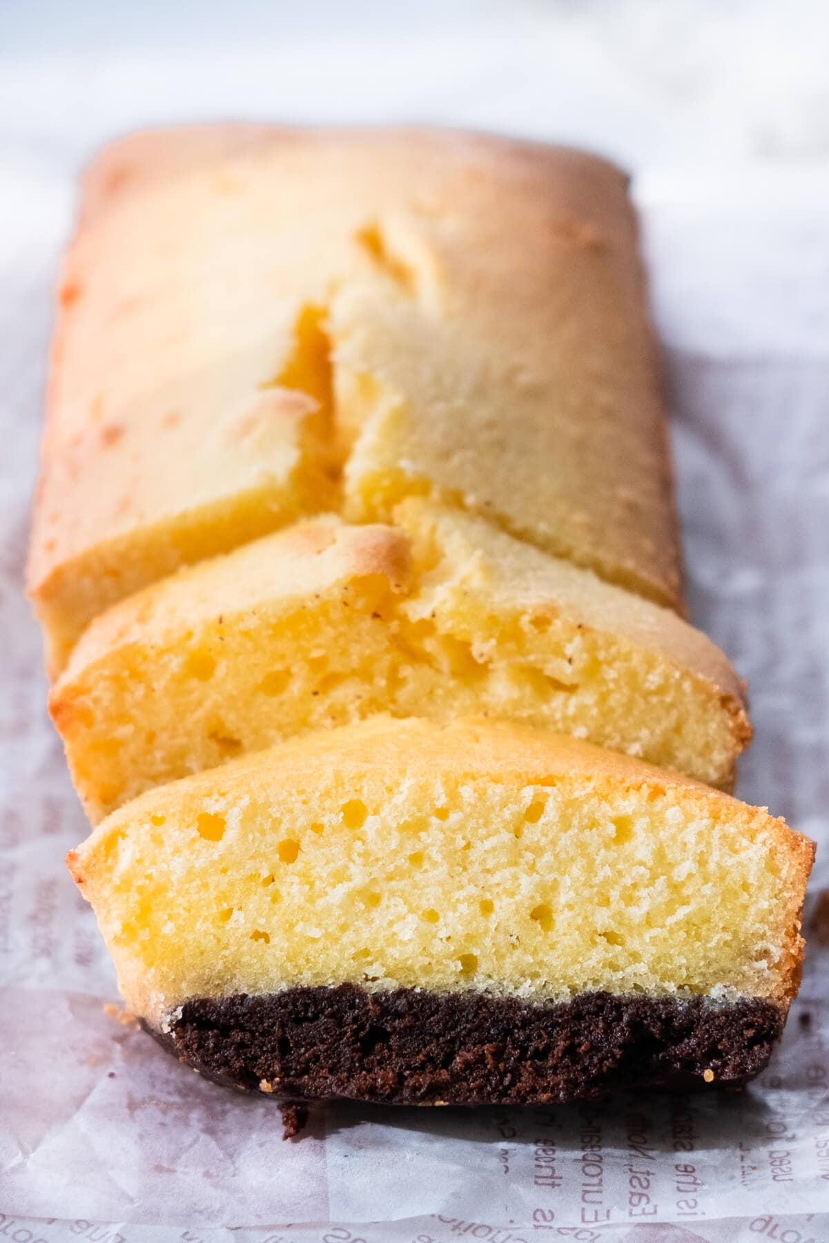 Brownie butter cake recipe with a brownie layer, cut into slices.