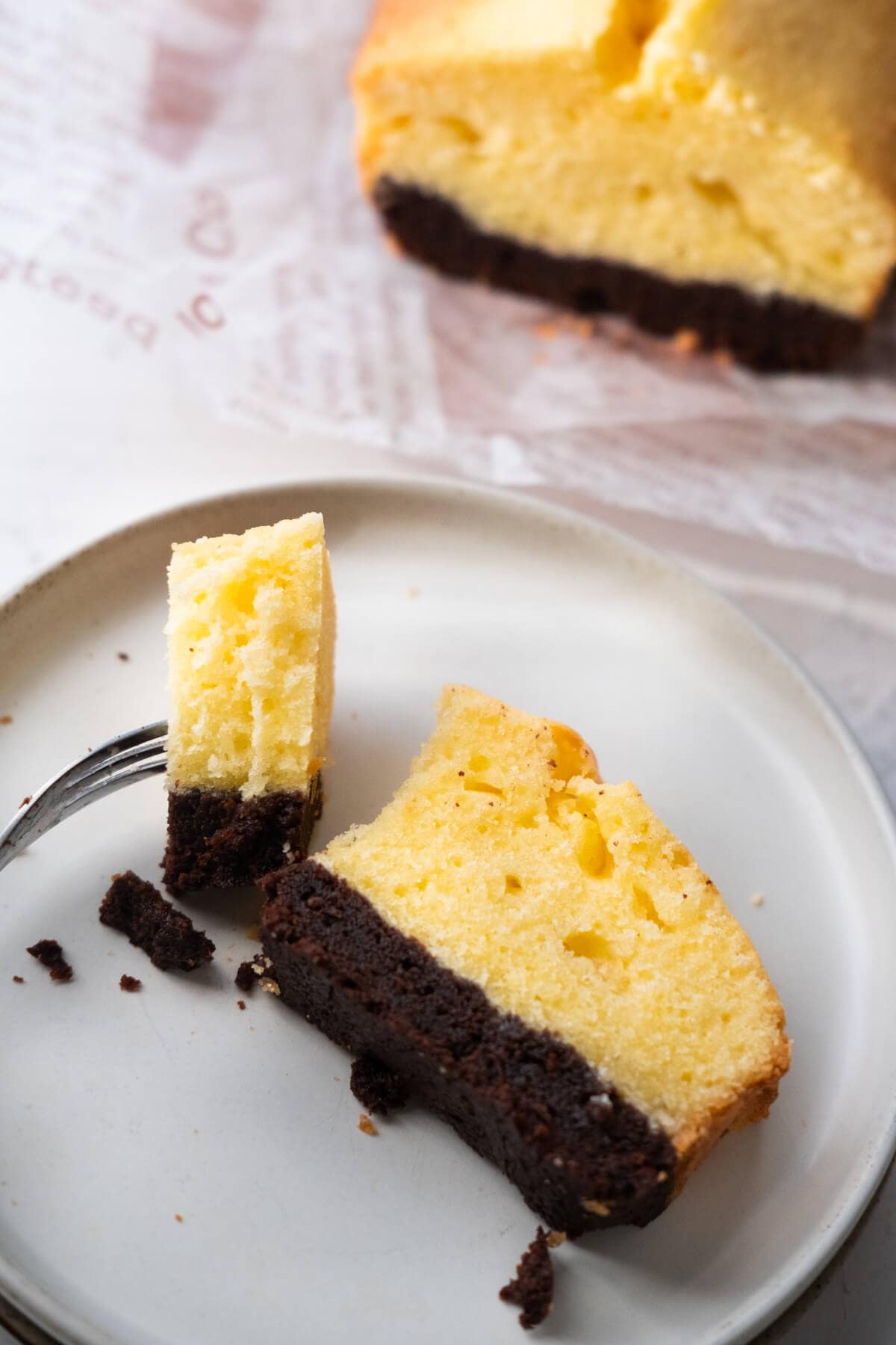 Fork piercing a small slice of butter brownie cake.