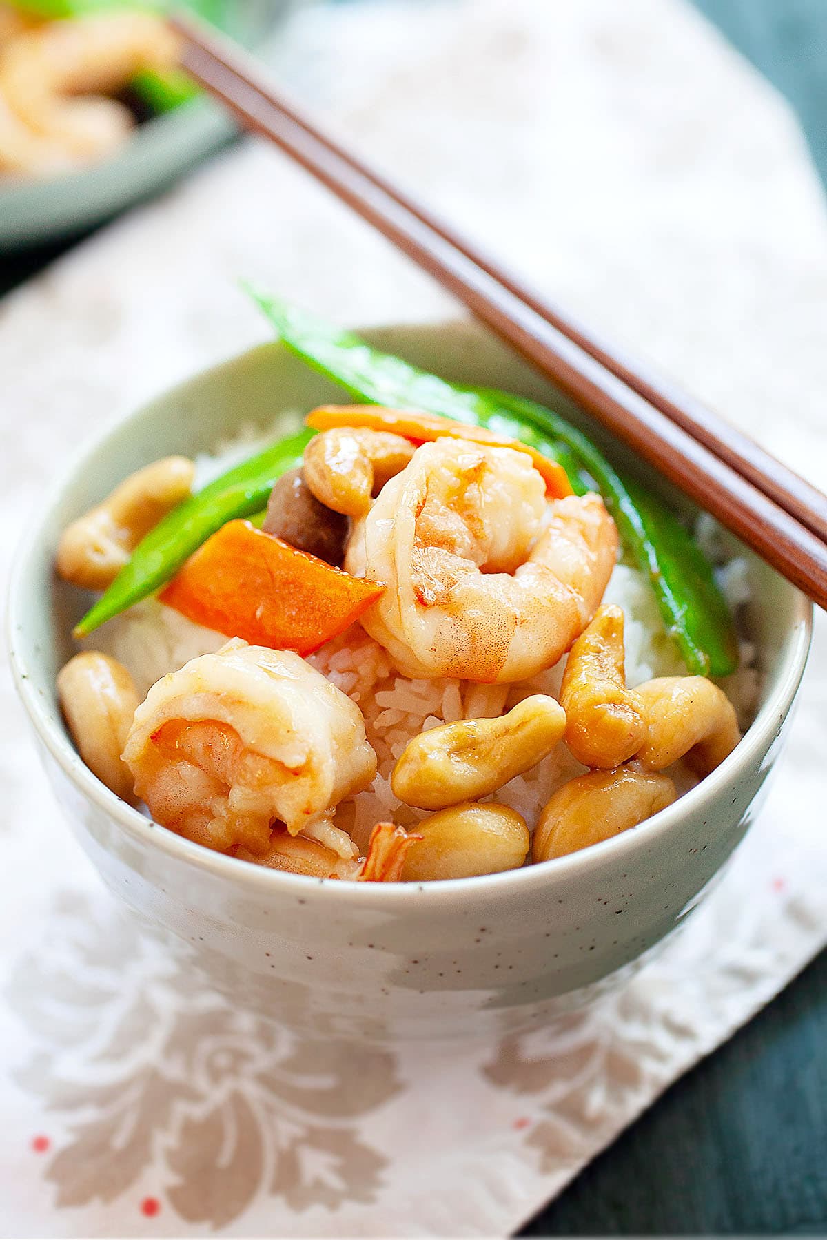 Cashew shrimp served in a bowl with steamed rice.