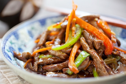 Easy and delicious beef stir-fried with red and green bell peppers, in a mildy spicy savory sauce.