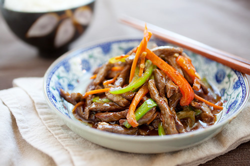 Chinese Szechuan beef stir fry in brown mild spicy sauce served in a plate.