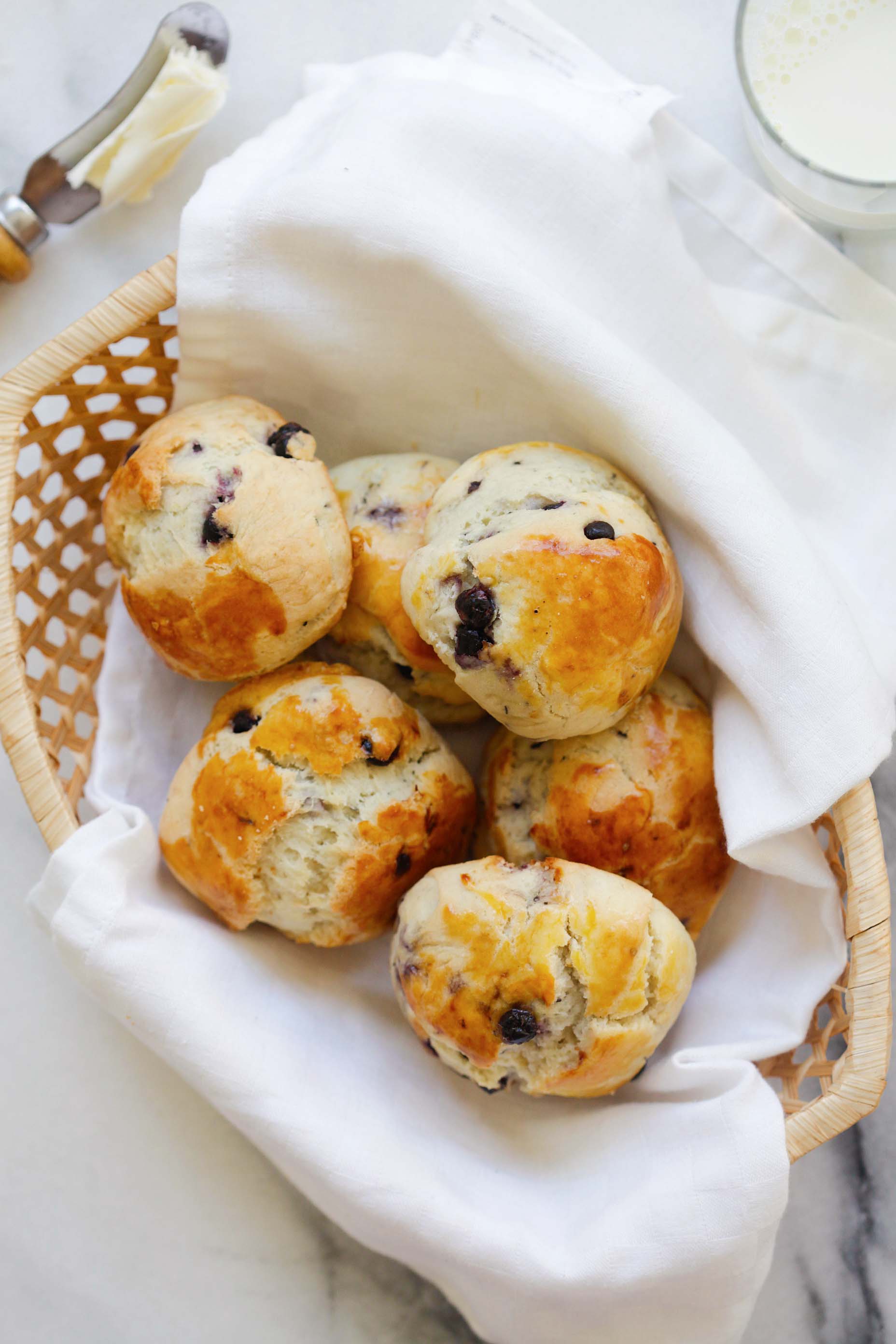 Delicious afternoon tea scones made with blueberries and placed in a basket.