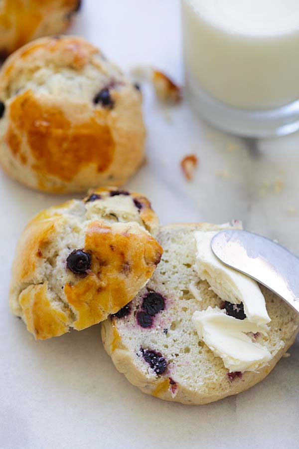 Easy English scone cut in half with butter spread on top, ready to be eaten.