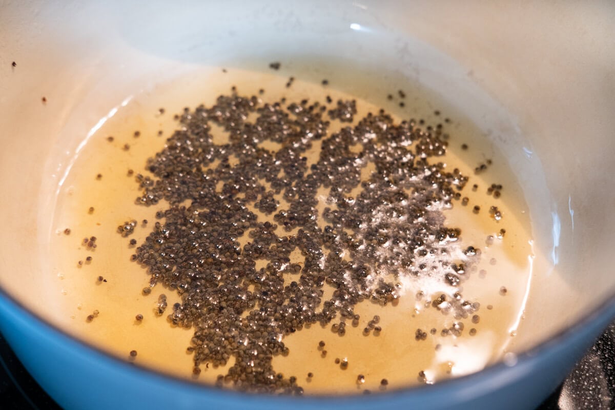 Cook the mustard seeds in a Dutch oven.