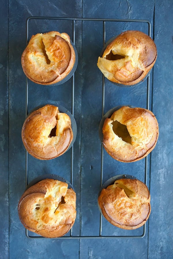 Six popovers on a rack, made super easy and golden brown.