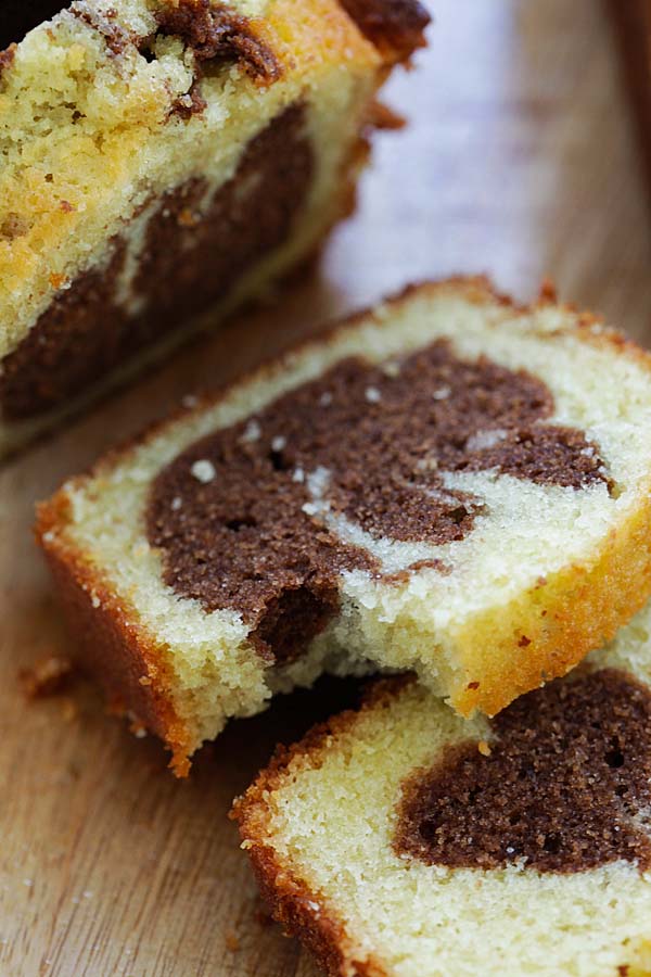 Taking a bite from a piece of homemade marble cake made with cocoa powder.