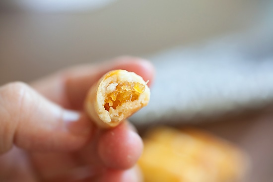 Homemade pineapple nastar rolls in half filled with pineapple jam.