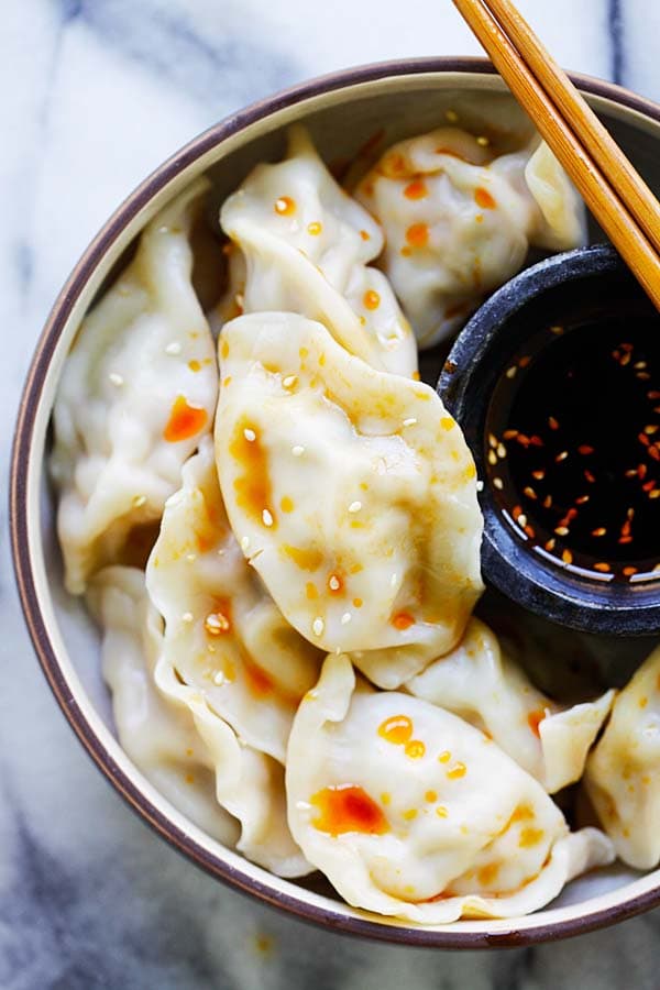 Delicious homemade Pork Shrimp and Napa Cabbage jiao zi with a side of dumpling chili vinegar dipping sauce.