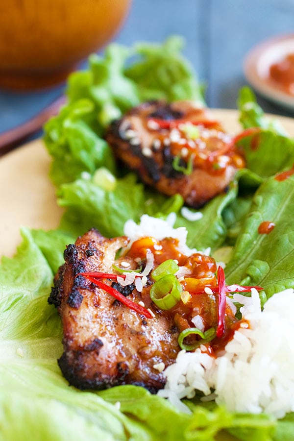 Korean BBQ Chicken (Dak Gogi) wrapped with lettuce leaves topped with Korean homemade spicy sauce and steamed rice ready to serve.