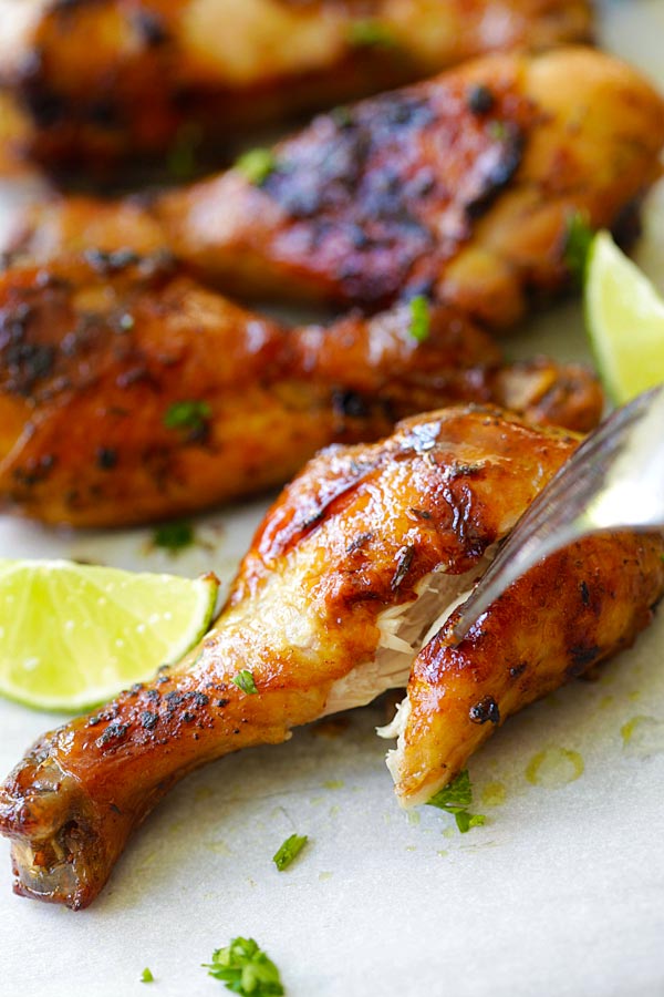 Easy and quick grilled jerk chicken drumsticks poked with a fork.