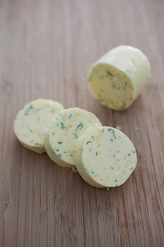 cylindrical homemade garlic butter sliced in round pads.