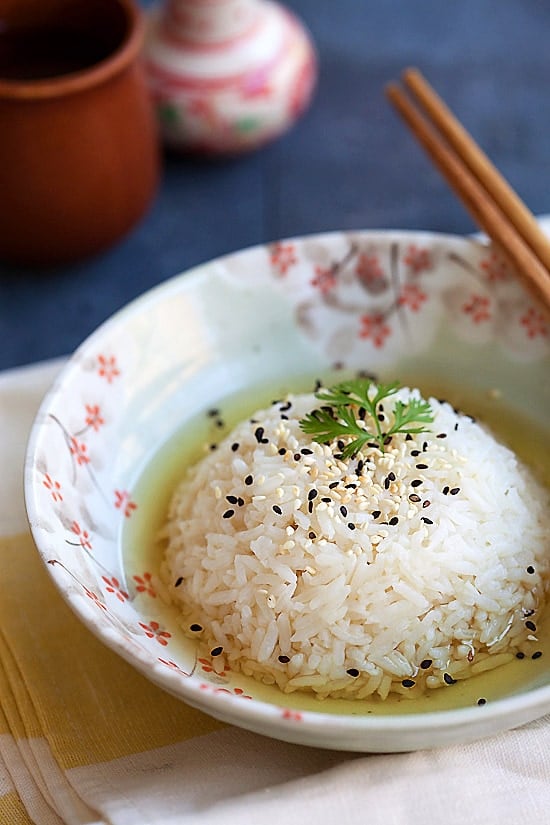 Easy Green Tea Rice in a bowl with a pair of chopsticks.