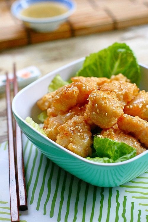 Honey chicken recipe with crispy chicken in a bowl covered in honey sauce.