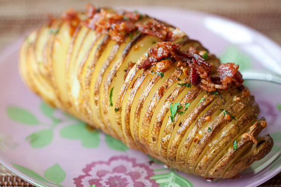 Easy and cheesy Hasselback Potatoes with bacon & parmesan ready to serve.