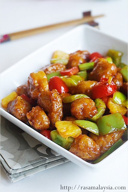 A white bowl full of sweet and sour pork made with an easy sweet and sour pork recipe.