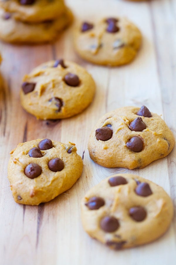 Easy and quick homemade chocolate chip cookies made with pumpkins on wooden chopping board.