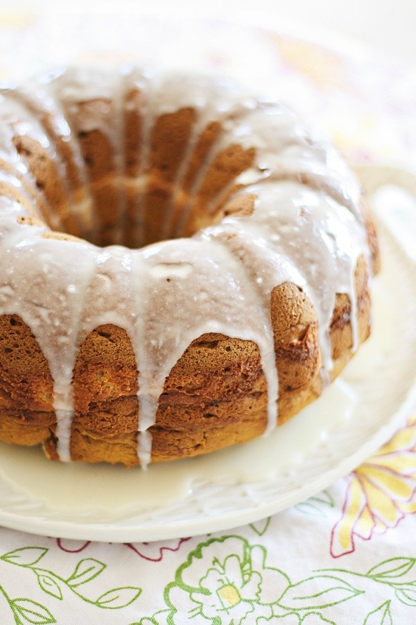 A slice of easy and delicious homemade bundt cake recipe with pumpkin and cream cheese served in a plate with a fork.