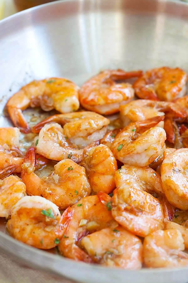 Hawaiian style garlic butter sauteed shrimp with lemon juice and white wine in a skillet.