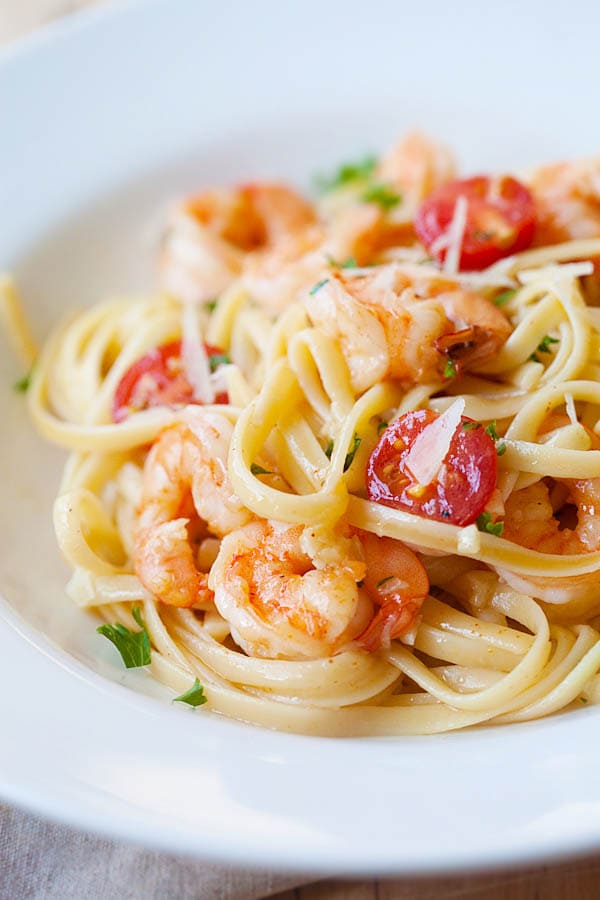 Shrimp scampi on a plate with garlicky shrimp scampi sauce and parsley, ready to serve.