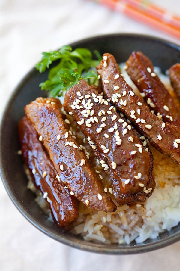 Homemade beef with brown teriyaki sauce topped with sesame seeds ready to serve.