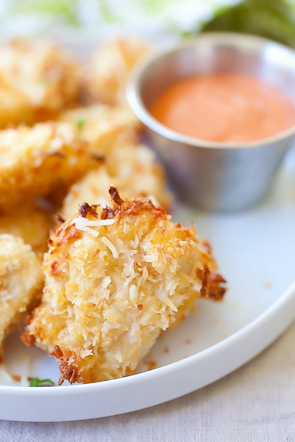 Homemade easy crispy nuggets with real chicken & Parmesan in a plate with a side of spicy ketchup dipping sauce.