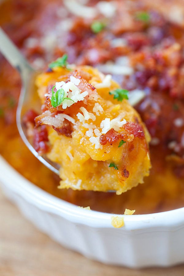 Easy Parmesan Bacon Pumpkin Mashed Potatoes scooped with a spoon.