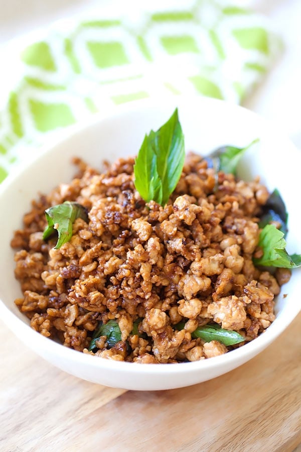 Thai Basil Chicken with ground chicken, basil leaves, and chilies in a serving dish.
