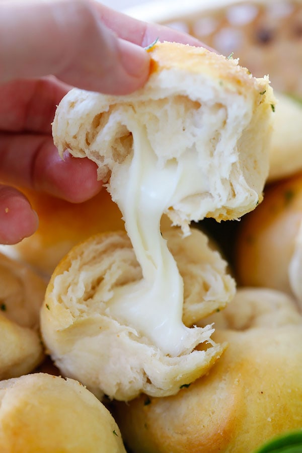 Easy and quick garlic herb cheese bombs in half with string Mozzarella cheese.