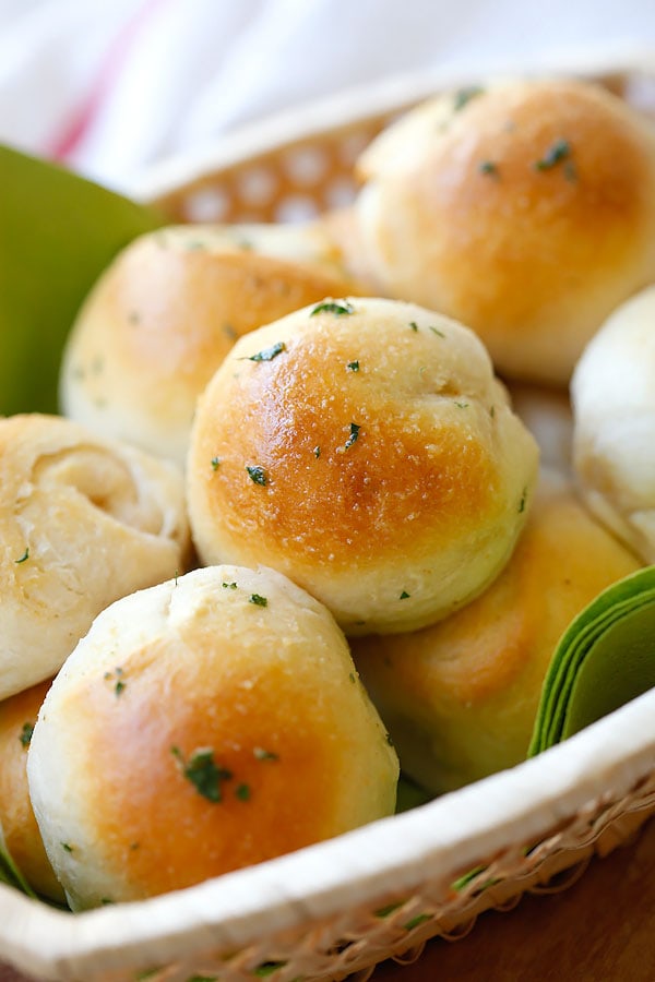 Garlic Herb Cheese Bombs topped with garlic herb butter, served in a basket.