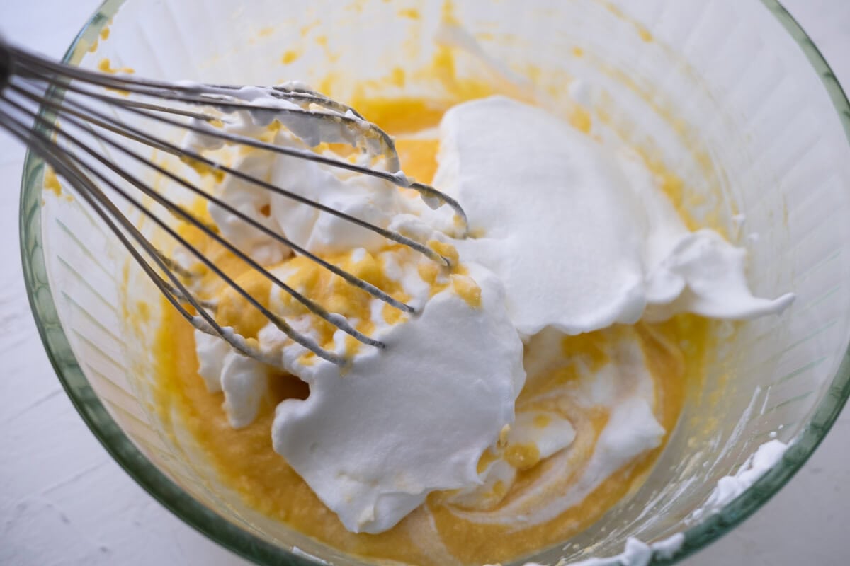 Egg white mixture and egg yolk mixture in a bowl.