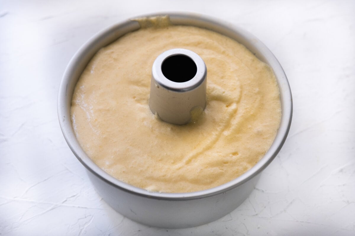 Parmesan chiffon cake mixture in a tube pan.