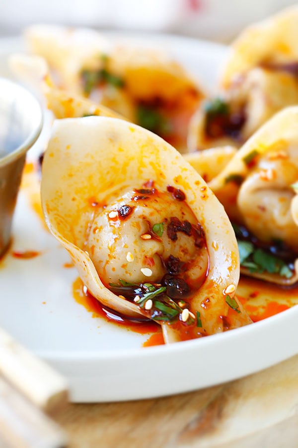 Easy and authentic boiled Szechuan Chinese pork dumplings with spicy red oil ready to serve.