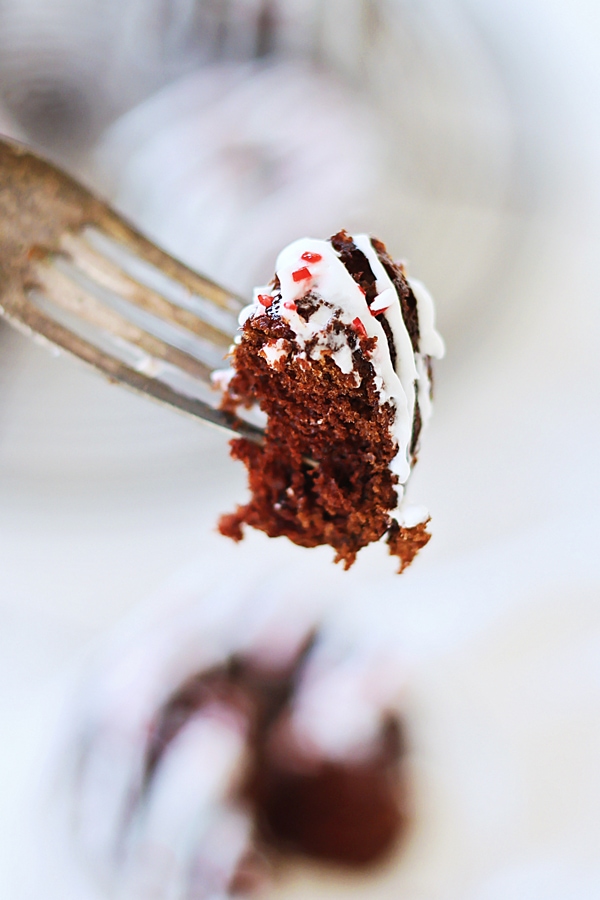 'A piece of chocolate bundt cake pick with a fork.
