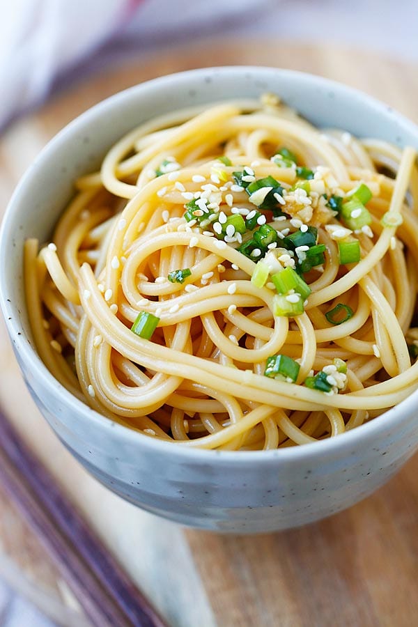Quick and easy Asian-flavored spaghetti with soy sauce, oyster sauce, garlic and sesame topped with chopped scallion.