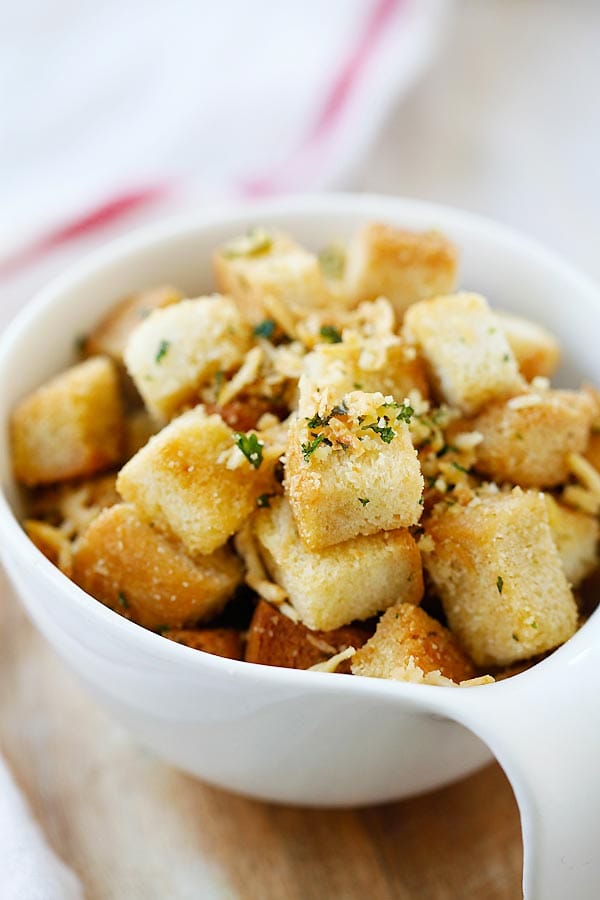 Easy homemade Garlic Herb Parmesan Croutons for soup and salad in a white bowl.