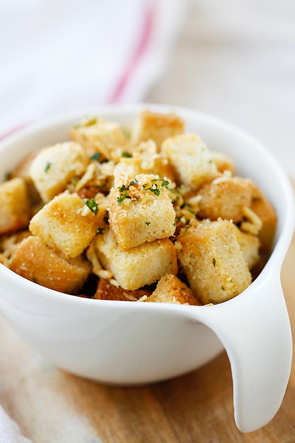 Easy homemade crispy baked croutons with garlic butter herb with Parmesan cheese, ready to serve.