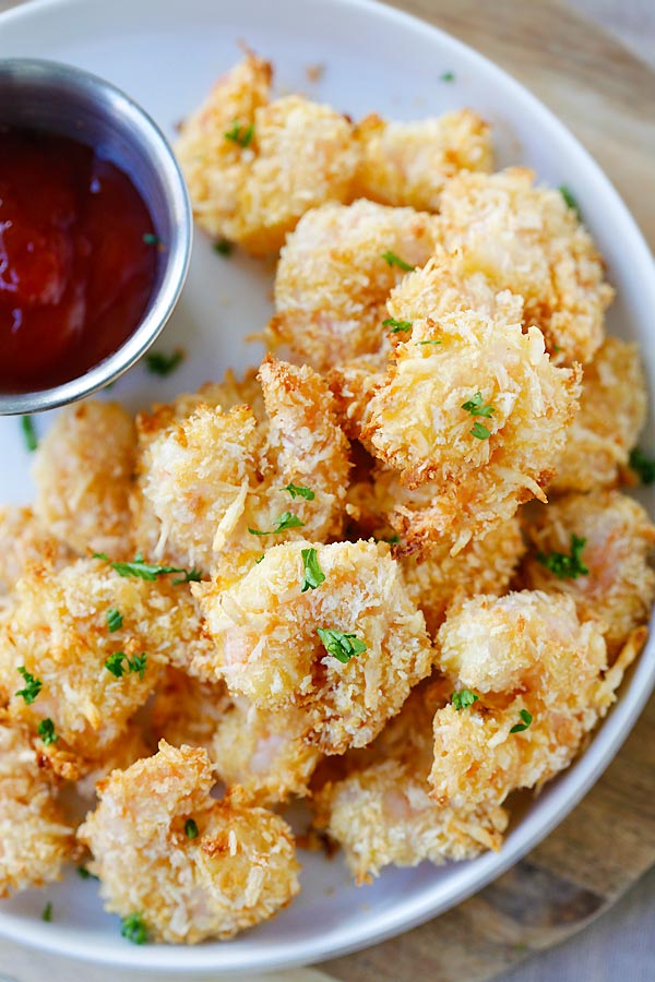 Homemade healthy Parmesan Baked Popcorn Shrimps with a side of ketchup dipping sauce.