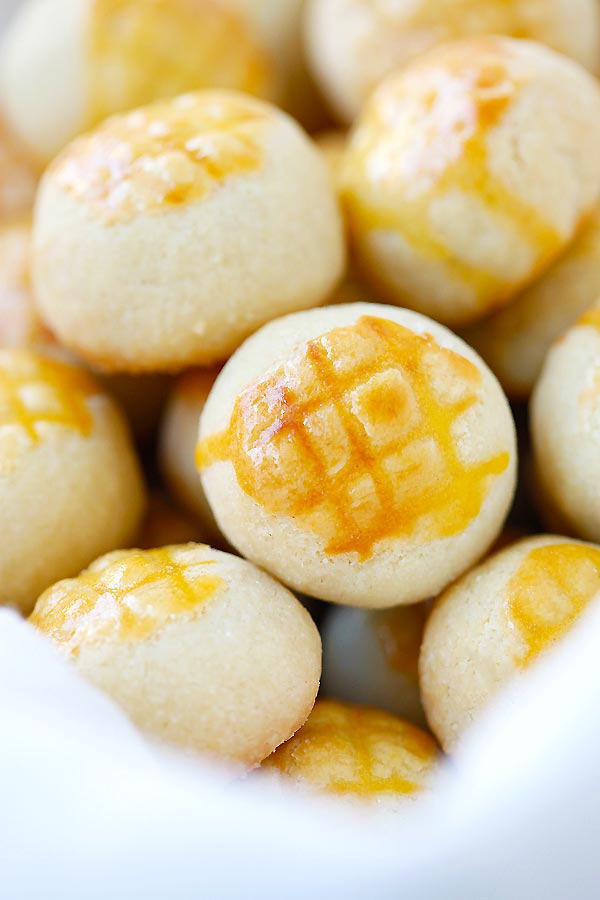 Chinese mini pineapple cookie pastries, stacked together in a basket.
