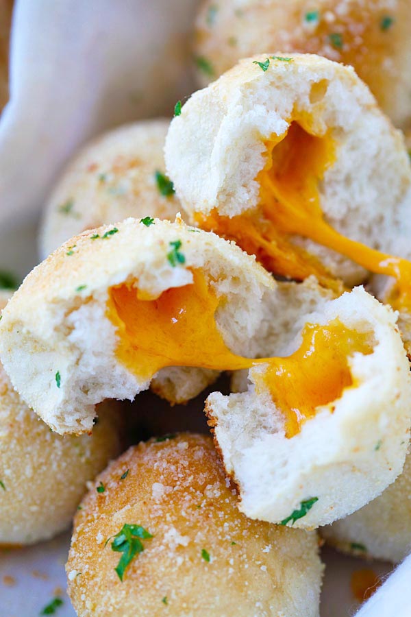 Quick and easy Garlic Cheddar Cheese Bombs in half with melted cheddar cheese.