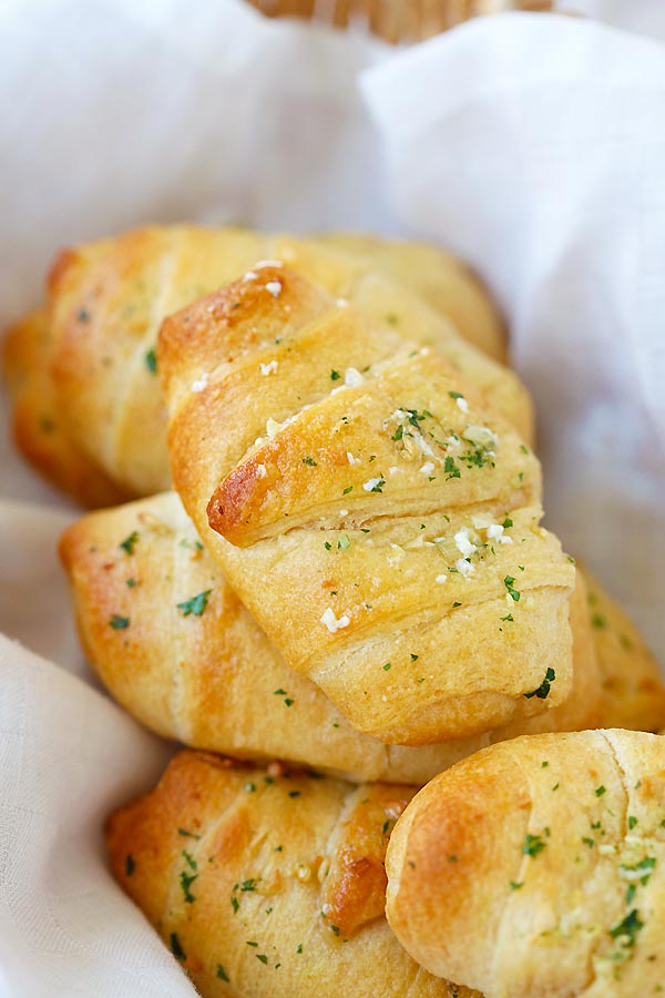 Easy and quick homemade Garlic Butter Cheesy mini Crescent Rolls stacked together.