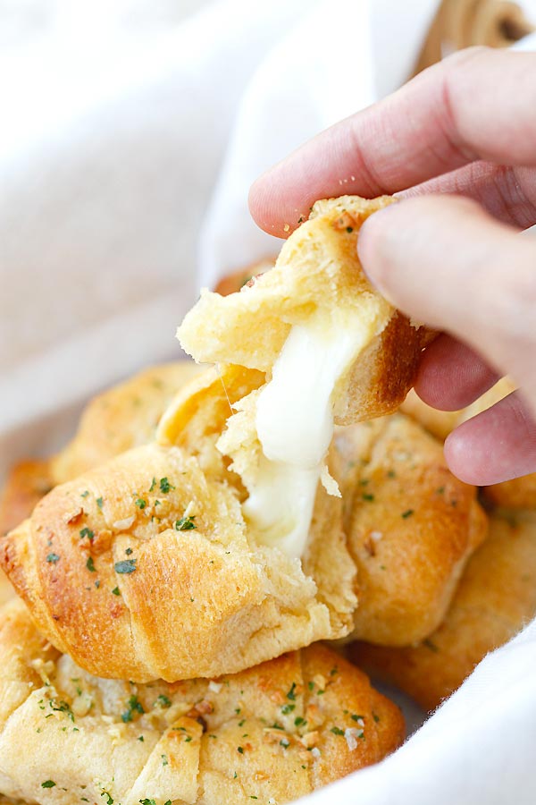 Closed  up stringy cheese Garlic Butter Cheesy Crescent Rolls in half.