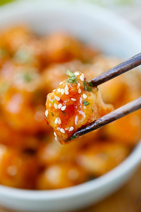 A piece of Thai sweet chili chicken on a chopstick.