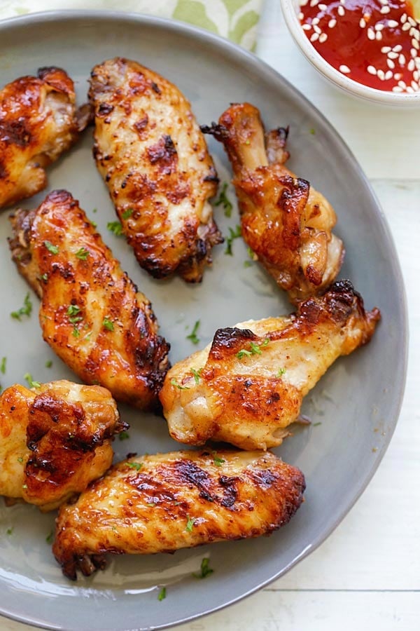 Asian style grilled chicken wings marinated with ginger, garlic, soy sauce and honey ready to serve.