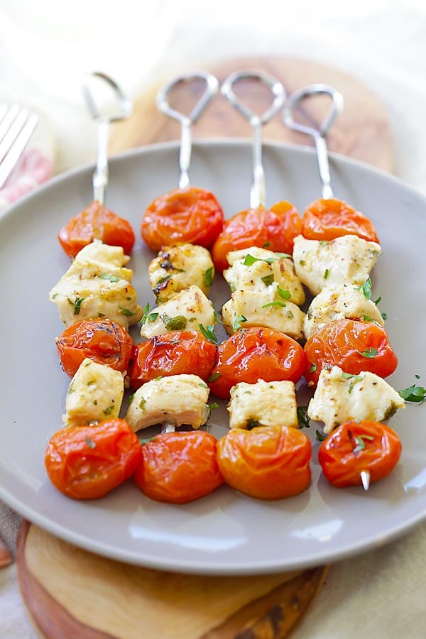 Grilled Greek Chicken Kebab with garlic, lime juice, olive oil and grape tomatoes on a plate.