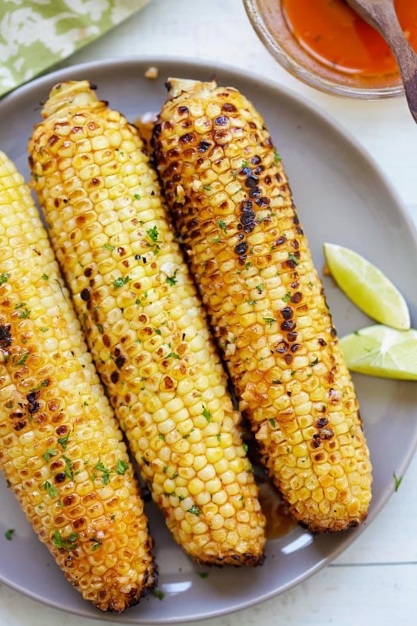 Seasoned grilled corn on the cob with honey glaze and butter.