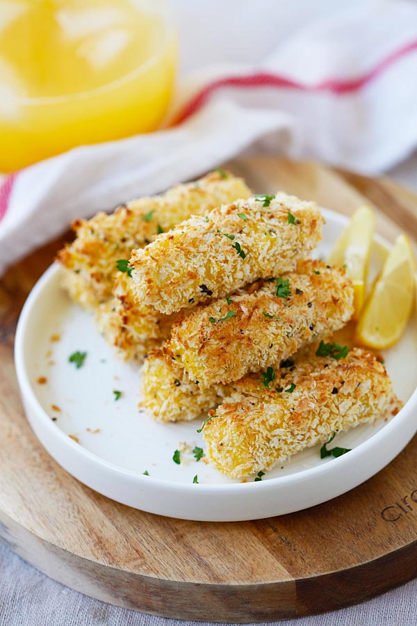 Baked Mozzarella Cheese Sticks with panko stacked together in a plate.
