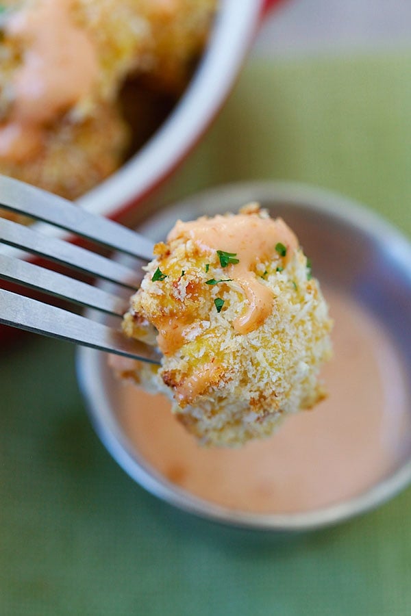 Crispy and healthy homemade parmesan baked cauliflower in Japanese panko in a fork.