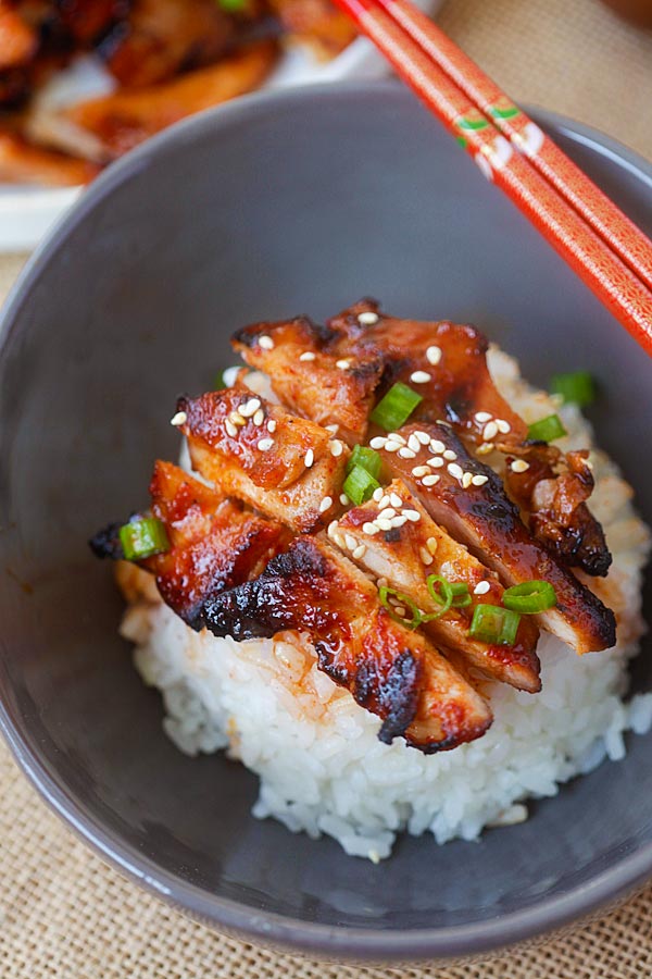 Spicy Korean chicken sliced into pieces and served on top of steamed white rice.