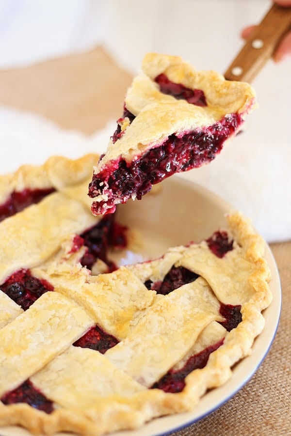 Easy homemade triple berry pie filling recipe with frozen berries sliced with a pie server.